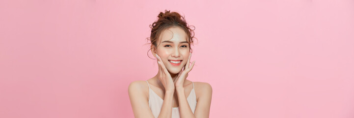 beauty Asian woman with K-beauty makeup showing fresh and clean skin isolated on pink background - 702710066