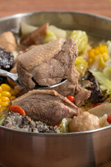 Delicious ginger duck hot pot soup with fresh vegetables in Taiwan.