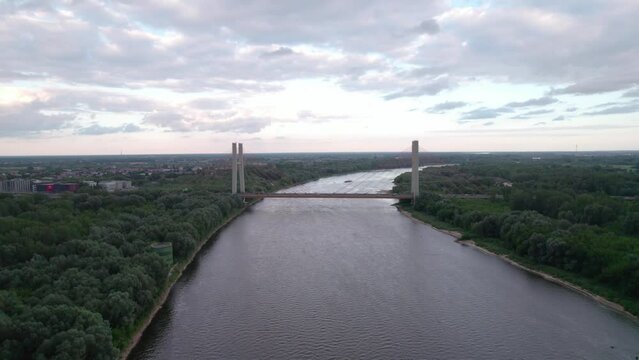 Captured by drone, the aerial view of the Vistula River in Warsaw reveals the majestic Siekierkowski Bridge in the foreground.