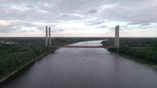 Captured by drone, the aerial view of the Vistula River in Warsaw reveals the majestic Siekierkowski Bridge in the foreground.