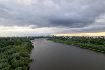 From a drone's perspective, the Vistula River in Warsaw unveils its scenic beauty, winding through the cityscape. 