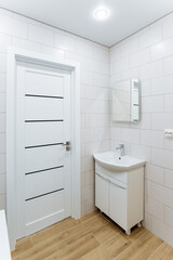 There is a bathroom, a bedside table with a sink in the corner of the room, a make-up mirror, a washbasin in the toilet.