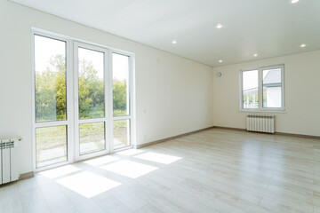 A bright room in the house, an empty living room interior, a floor-sized plastic window,