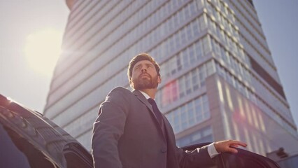 Boss opening automobile door going outside. Successful manager getting out car