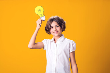Child girl holding paper bulb. Success, motivation, winner, genius, idea concept