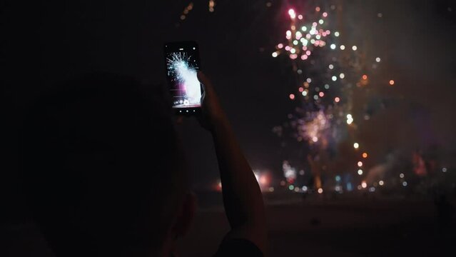 New Year Eve Fireworks Display on Bali Beaches and Silhouette of People Celebrating it in Slow Motion