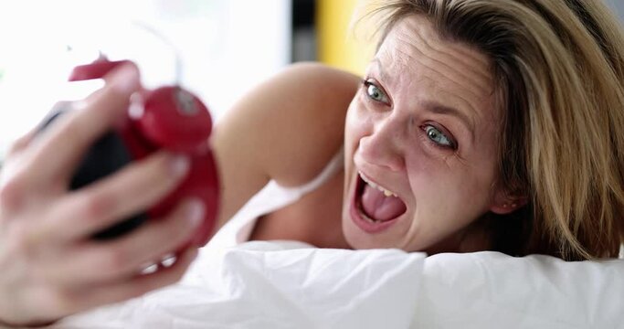 Oversleeping at work and screaming woman at alarm clock. I wake up feeling anxious and late