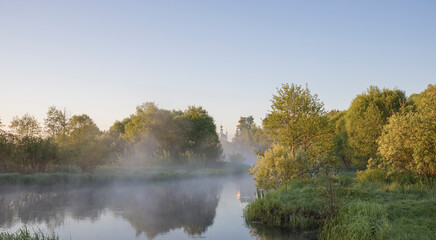 Early morning landscape by the river, dawn and fog