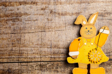 Easter Bunny and Colorful easter eggs on wooden background with copy space