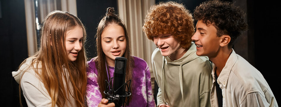 cheerful talented teenagers in casual attires singing together in studio, musical group, banner