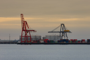 port cranes against sunset background