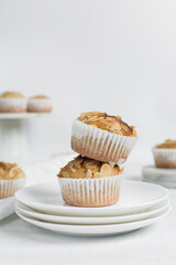 almond muffins on a white plate, homemade bakery style almond muffins on a white background