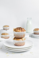 almond muffins on a white plate, homemade bakery style almond muffins on a white background