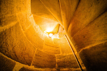 Stone tower stairs with warm light. Stairway to heaven