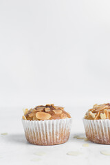 vanilla almond muffins on a white table, homemade bakery style almond muffins on a white background