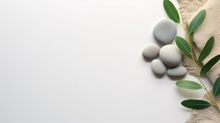 Fototapeta na wymiar A branch of olive leaves and stones on a white background. This versatile asset is suitable for various designs like wellness and spa, nature and environment, and Mediterranean-inspired themes.