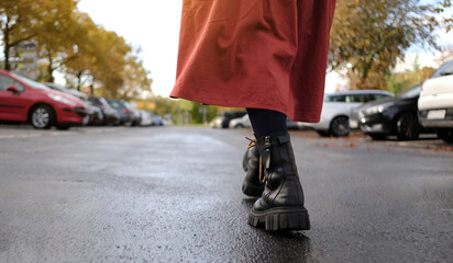 Woman'S Black Leather Boots On City Street - obrazy, fototapety, plakaty