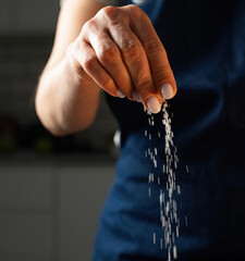 Woman Salts Food With A Pinch Of Salt