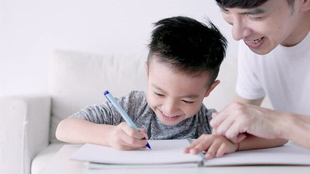 Young father checking homework helping  child  with study at home