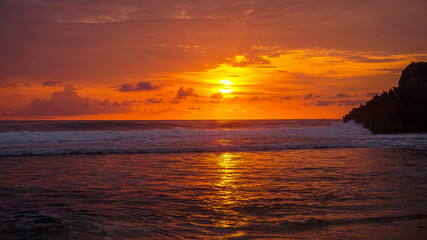 Naklejka premium Beautiful sunset at Kukup Beach in Central Java, Indonesia
