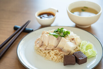 Closed up Hainanese chicken rice with soup and black soybean sauce, traditional Chinese food
