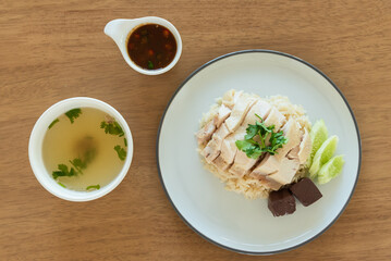 Top view Hainanese chicken rice with soup and black soybean sauce, traditional Chinese food
