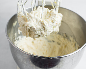 Cream colored american buttercream on a whisk attachment, russian buttercream on a whisk