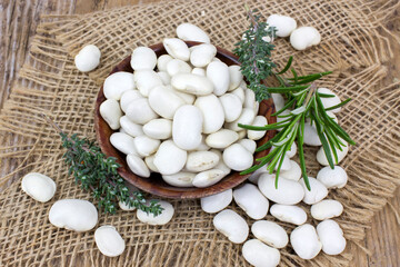 Obraz na płótnie Canvas white beans and herbs in a bowl