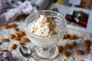 Sweet dessert: soft creamy ice cream in a beautiful creamer. Delicious ice cream with nuts for...