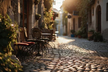 Foto op Canvas old European street, cobblestone, café chairs © Marco Attano