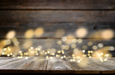 Empty rustic wooden table with blurred glitter lights background. Christmas lights on empty wooden table. Xmas holidays wallpaper.