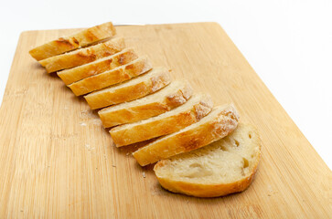 Sliced bread on a wooden board. Isolated on white background, healthy food concept.