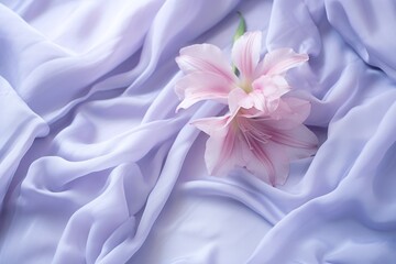  a pink flower sitting on top of a bed covered in a white sheet with a pink flower sticking out of it's center.