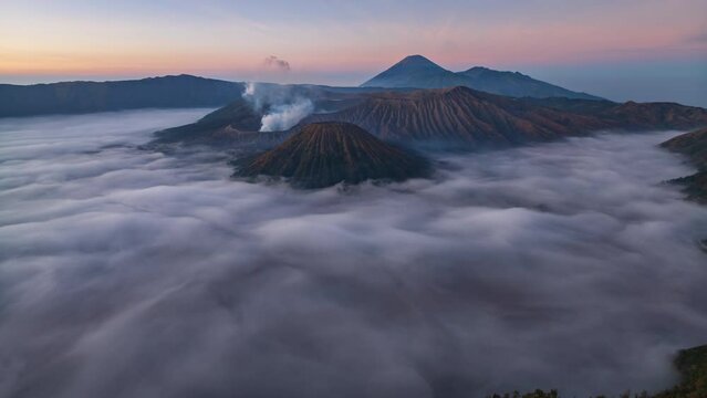 Hyperlapse aerial view flying to mount Bromo active volcano above sea of clouds, Java, Indonesia 
