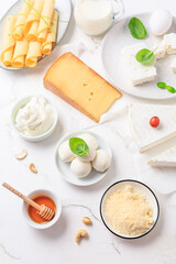 Assortment of different dairy products on white table