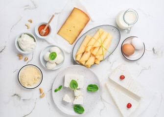 Assortment of different dairy products on white table