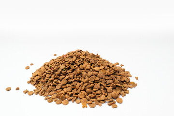 Pile of dry animal food on a white background. Food for dogs and cats in granules