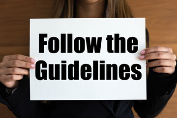 Follow the guidelines. Woman with white page, black letters. Rules, manual, advice, instructions.