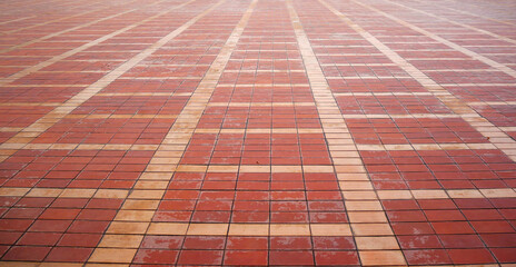 Red brick tile floor neatly arranged on a patterned texture background.