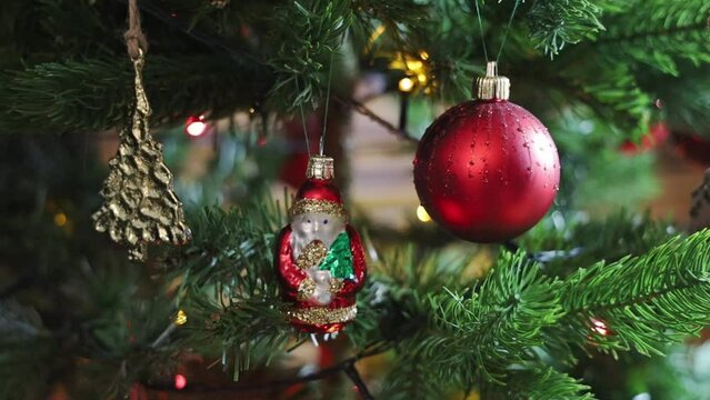 Christmas tree decorated with balls and gerland with flashing lights. 