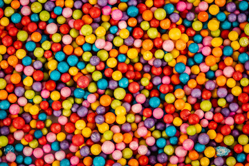 Fototapeta na wymiar Decorative polystyrene colorful balls background. Abstract bright wallpaper. Many styrofoam plastic marbles, balloons. Abstract festive backdrop.