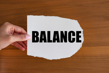 Balance. Woman hand holds a piece of paper with a note, balance. Stability, offset, settle,...