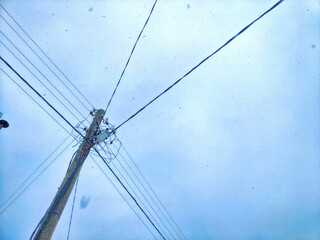 Old pole with wires against the sky. Electric transmission line. Eco-friendly energy