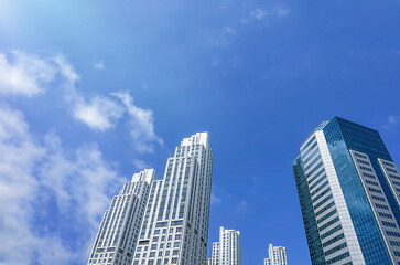 Buildings, skyscrapers against the blue sky. Bottom view. Outdoors. Business background. Day. Tall...