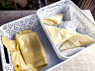 Plastic bag folded into a triangle for storage. Ways of storing and laying at home