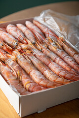 Box with frozen langoustines, shrimp