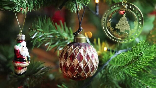 Christmas tree decorated with balls and gerland with flashing lights. 