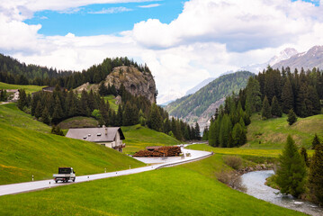 Countryside mountain road in Swiss alps within country houses