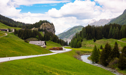 Fototapeta na wymiar Countryside mountain road in Swiss alps within country houses