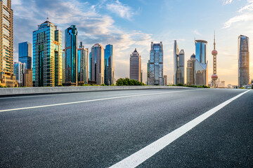 Empty asphalt road and city buildings skyline in Shanghai
